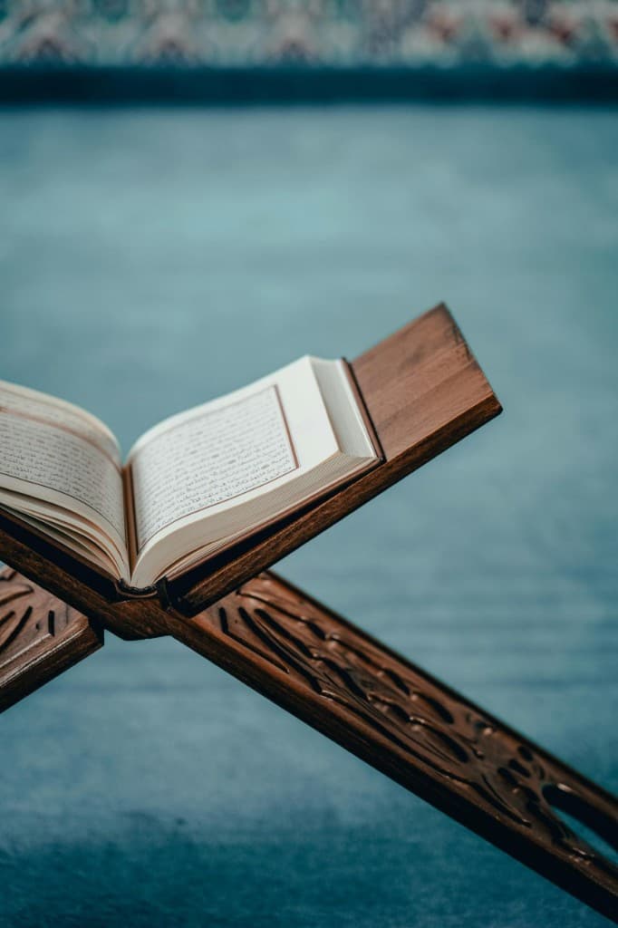Open Quran on a carved wooden rehal